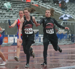 Snow was coming down by the time the 4x400 was held. Here Kristin Hill hands off to MaKayla Schaeffer.