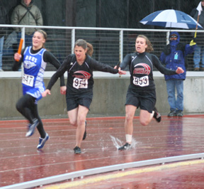 The rains hard started coming down heavily by the time the 4x100 started as evidenced by the splash Kristin Hill makes as she hands off to Shelby VonBargen.