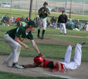 Kyle Holthaus just barely beats the pickoff throw back to the bag at first in the championship game.