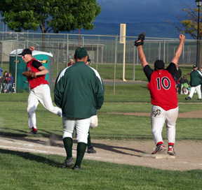 First baseman Joe Schumacher throws his hands in the air after catching the toss from pitcher Devin Schmidt, at left pumping his right fist, for the last out of the championship game.