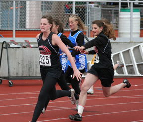 Shelby VonBargen hands off to NaTosha Schaeffer in the 4x200 relay.