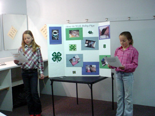 Nicole & Ellea Poxleitner, members of the Keuterville Livestock 4-H Club, presenting their 4-H demonstration.