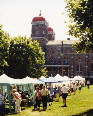 Arts and crafts fair vendors on the Monastery lawn.