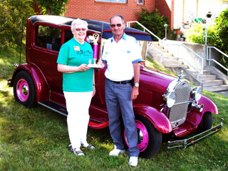 The Berry Prestigious winner at the Show and Shine. Sr. Carol Ann Wassmuth, presenting the trophy, got a ride in the car from owner Allyn Palmer of Nampa.