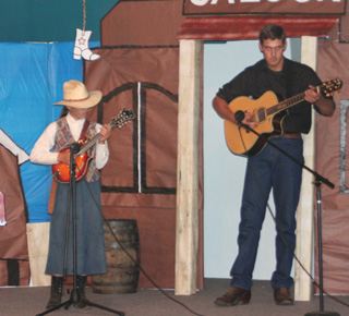 Josie Turner played bluegrass music on the mandolin to win the 5-12 year old age group at the 2-Minute Talent Show. Accompanying on the guitar is her brother Ross.