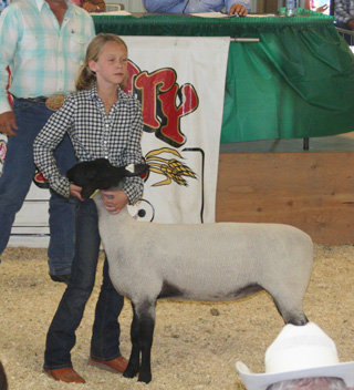 Kally Arnzen with her reserve champion quality market lamb.