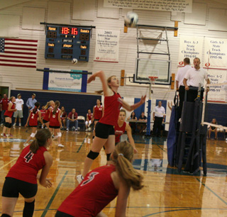 Kayla Johnson leaps high for a spike at the Jamboree as Megan Sigler, Tanna Schlader and Shelby Duman look on.