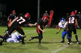 Brock Heath makes his way through a big hole for Prairies final touchdown of the game. 77 is David Johnson (who seems to be patting Heath on the rump as he goes by) and #12 is Tim Frei.