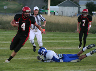 Devin Schmidt leaves a potential tackler grasping at air as he heads for the end zone for one of his 4 touchdowns. At right is Beau Schlader.