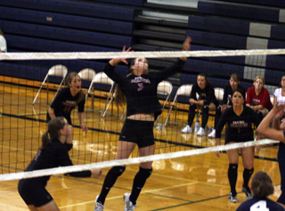 MeShel Rad goes up for a spike as Megan Sigler, Tanna Schlader and Fran Johnson watch.