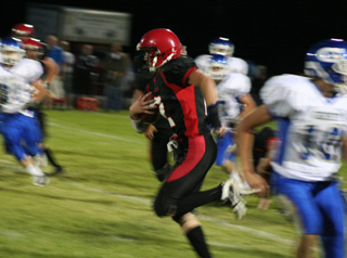 Seth Guyer breaks free for what wouldve been a 63 yard touchdown run if not for an early whistle by one of the referees. The Genesee player at right was going toward Devin Schmidt to whom Guyer had faked a pitch.