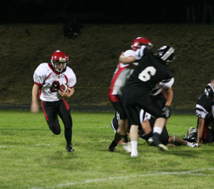 Brock Heath gets a block from Devin Schmidt as he takes the ball around right end.