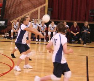 Brooke Schumacher makes a pass in the Troy match. Behind Brooke is Jamie Chmelik and #15 is Nicole Frei.
