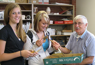 Students accept the used ceramics tools Ed Brannan donated to Prairies art classes.