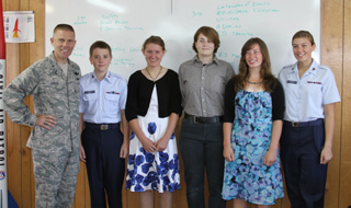 General Kwast, left, with Civil Air Patrol cadets including Rachel Uhlenkott, third from left, and Rachel Spencer, second from right.