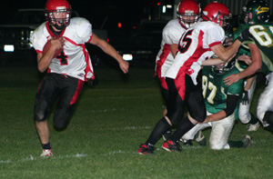 Josh Roeper and Colton Nuxoll seal off the Potlatch defenders as Devin Schmidt carries the ball.
