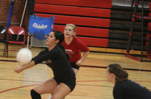 Fran Johnson makes a pass as Demetria Riener (in red) and Monica Lustig watch.