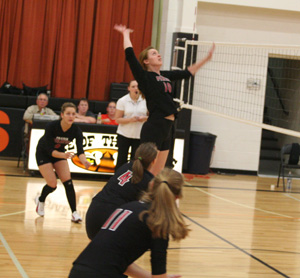 Kayla Johnson spikes the ball at Kendrick. Watching from left are Shelby Duman, Megan Sigler and Tanna Schlader.