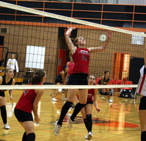 Kayla Johnson winds up for a spike against Clarkston. Also shown from left are Demetria Riener, Megan Sigler and Sam Poxleitner.