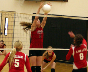 MeShel Rad blocks a St. John-Endicott spike attempt. In the background are Sam Poxleitner and Tanna Schlader.