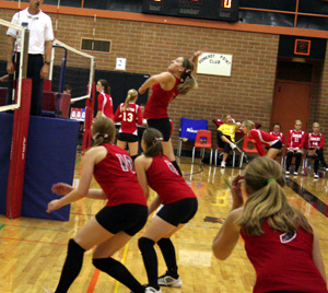 Shelby Duman winds up for a spike against Clarkston. Also shown from left are Kayla Johnson, Megan Sigler and Tanna Schlader.
