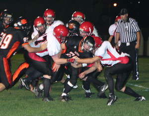 A host of Pirate defenders gang-tackle a Kendrick ballcarrier. The two in front are David Johnson and Justin Schmidt. Surrounding the runner appear to be Devin Schmidt, David Johnson, Colton Nuxoll and Ryan Dalgliesh.