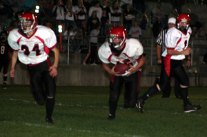 Kade Perrin, left, lead blocks for Garrett Schmidt on a fourth quarter run. At right is quarterback Troy Lorentz.
