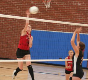 Kayla Johnson spikes the ball against Deary at the Genesee Tournament.