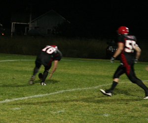 Colton Nuxoll is about to pick up a Lapwai fumble in the end zone for his first varsity touchdown. At right is Josh Roeper.