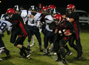 Garrett Schmidt carries the ball as Tim Frei, left, makes a block for him. Behind Schmidt is Colton Nuxoll.