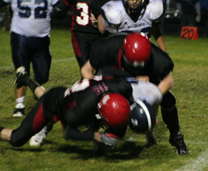 Tim Frei and David Johnson take down a Lapwai ballcarrier. Closing in from behind is Cody Schumacher.