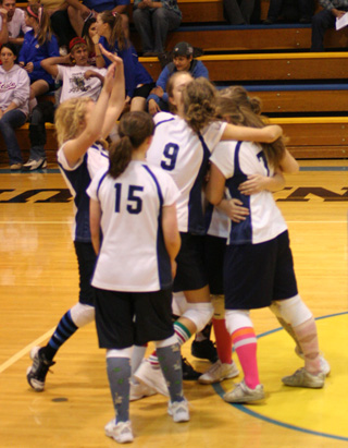 The Summit girls celebrate after outlasting Highland in their District Tournament opener.