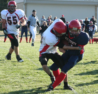 Tim Frei tackles a Lewis County ballcarrier as Josh Roeper looks on.