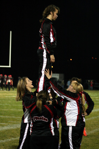 The football cheerleaders worked on pyramids during halftime. On top is Kylee Simmons.