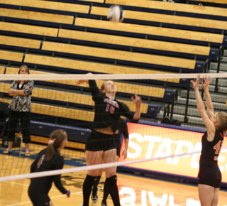 Kayla Johnson spikes the ball in the Kendrick match. At left is Megan Sigler.