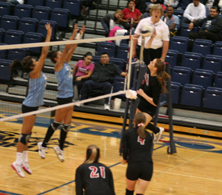 MeShel Rad looped around behind setter Megan Sigler, #4, for this spike against Lapwai. At left is Sam Poxleitner.