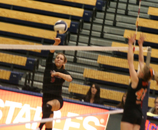 Shelby Duman goes crosscourt, away from the blocker, with a spike in the Kendrick match.
