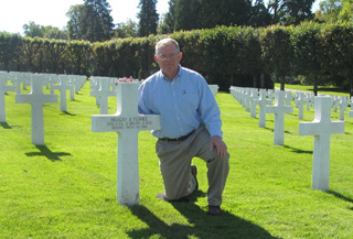 Father Jerry Funke with the grave marker for Hugo Funke. He brought dirt from Cottonwood on his visit and sprinkled it around the gravesites of Hugo Funke and Julius Holthaus.