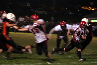 Garrett Schmidt bursts through a hole created by Josh Roeper and David Johnson. He wound up scoring a touchdown at the end of this 14-yard run.