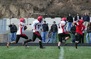 Devin Schmidt had David Johnson and Josh Roeper blocking in front of him on this screen pass. He appeared to score but it was called back when #1 for Wallace fell down and the referee saw it as a block in the back.