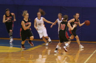 Kayla Johnson dribbles away with a rebound as MeShel Rad, Kendal Schumacher head upcourt and Megan Sigler, 10, gets ready to take a pass.