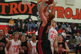David Johnson got inside for a lay-up against Troy. Also shown from left are Devin Schmidt, Justin Schmidt and Seth Guyer.