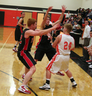 David Johnson and Seth Guyer put the pressure on a Troy player. In the background is Devin Schmidt.
