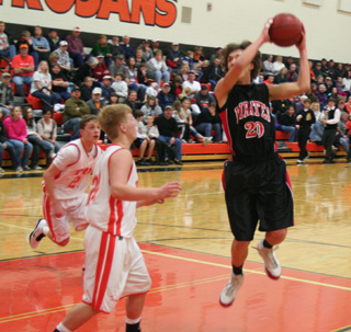 Justin Schmidt grabs an offensive rebound at Troy. He put it back for 2 of his 12 points in the game.