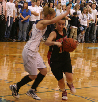 Megan Sigler tries to drive past a Grangeville defender.