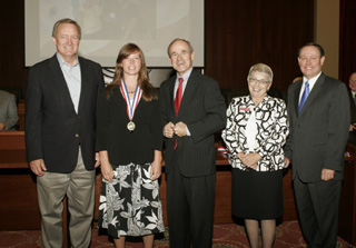 Rachel Spencer, wearing her Congressional Award Gold Medal, stands between Senators Mike Crapo and Jim Risch.