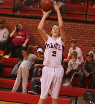 Beau Schlader attempts a 3-pointer from the corner. At left is David Johnson.
