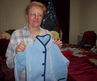 Sister Placida and one of the coats she made for underprivileged children.