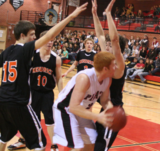 David Johnson looks for an opening to the hoop as he is double teamed by Kendrick defenders.
