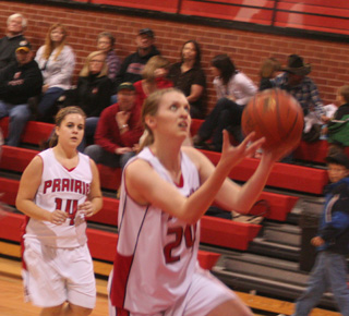 Kayla Johnson goes for a lay-up against Deary. Haleigh Schmidt watches.